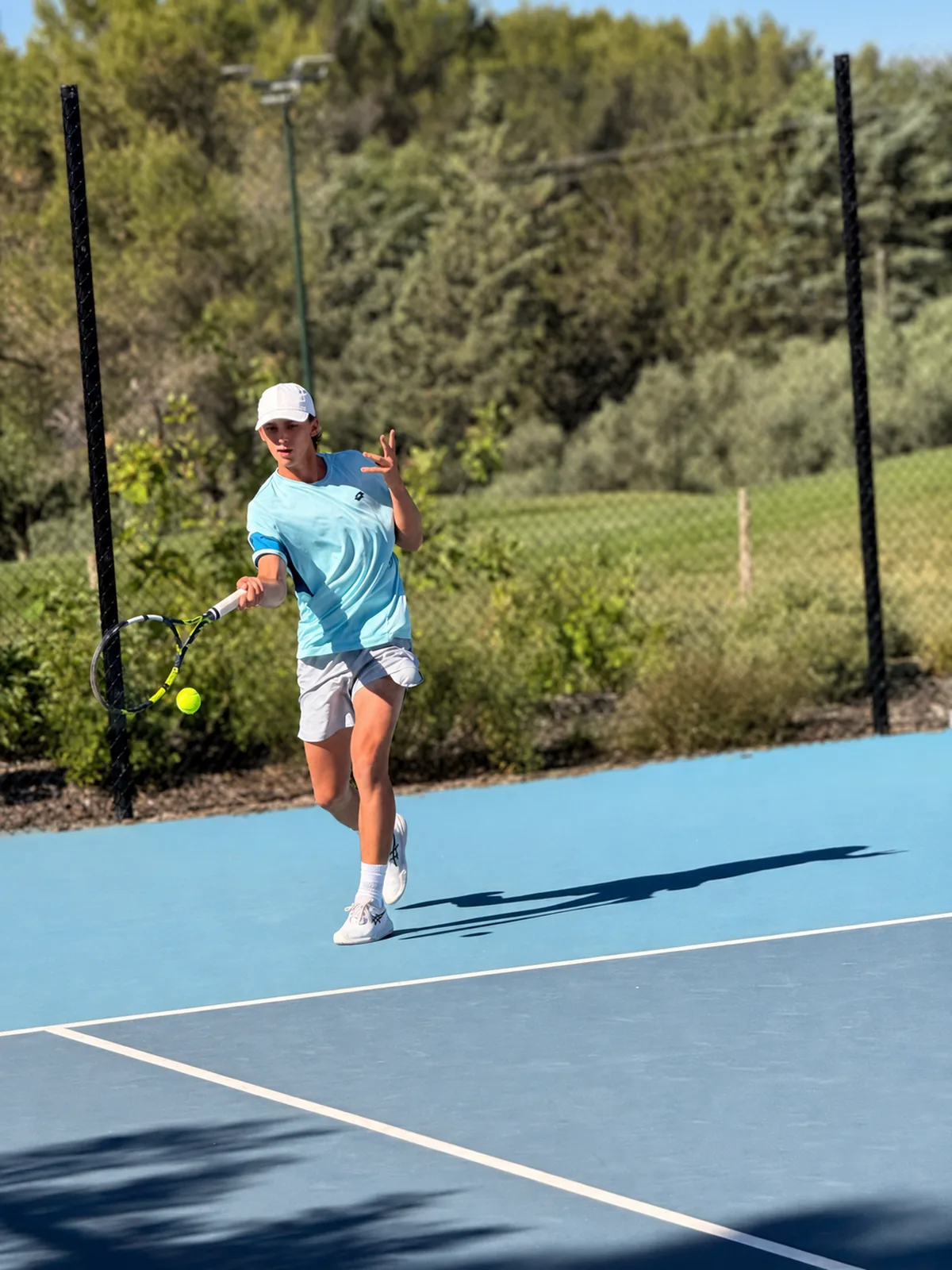 College tennis player hitting a forehand during a match in Florida