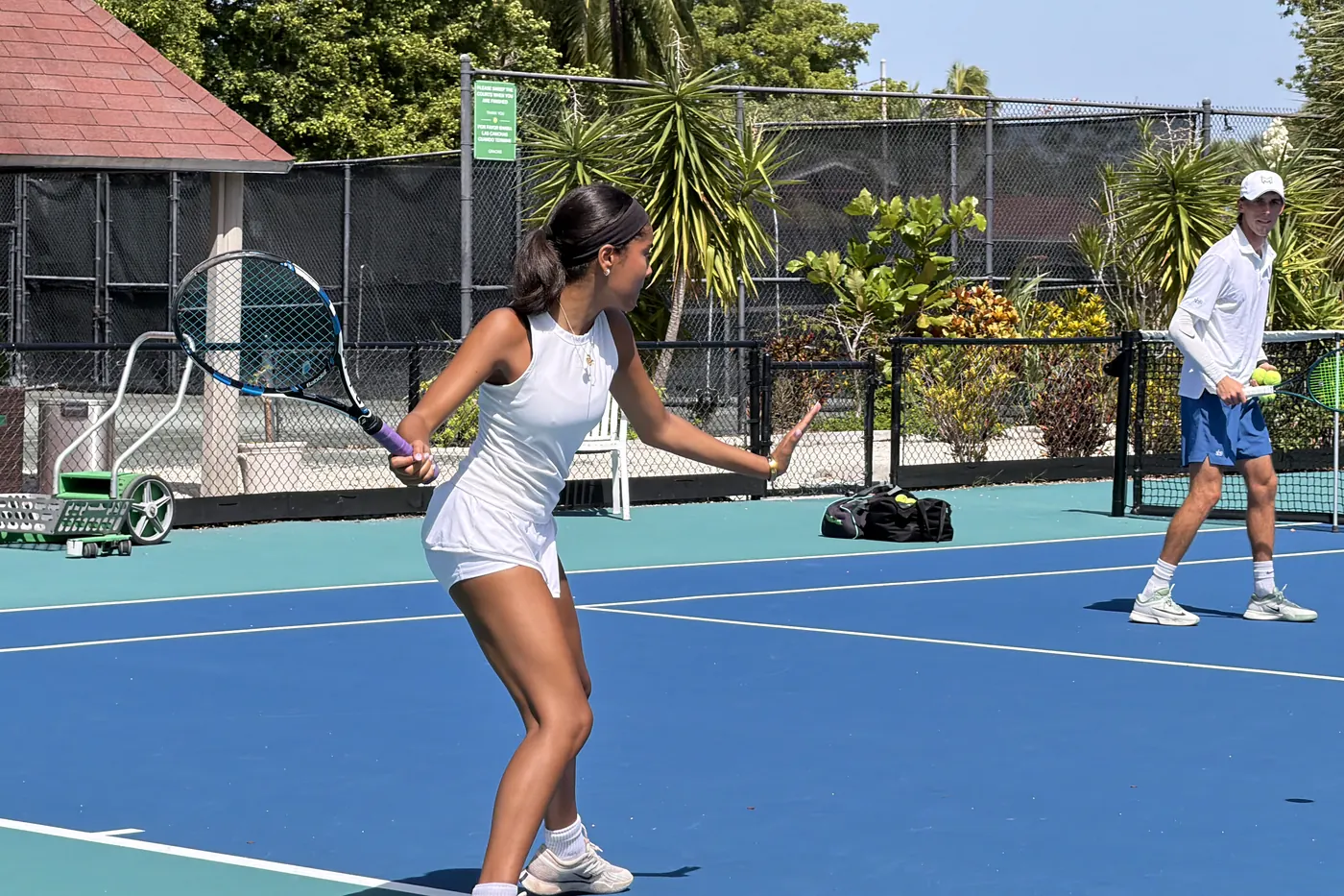 Coach Tom feeding from across the net during a semi-private lesson