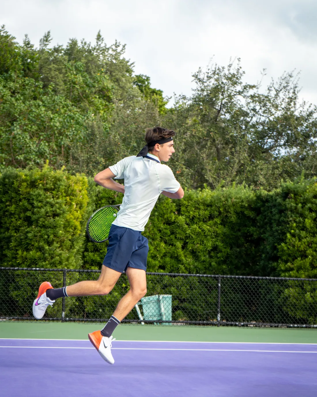 Coach Tom hitting a jumping forehand on a hard court in Tampa