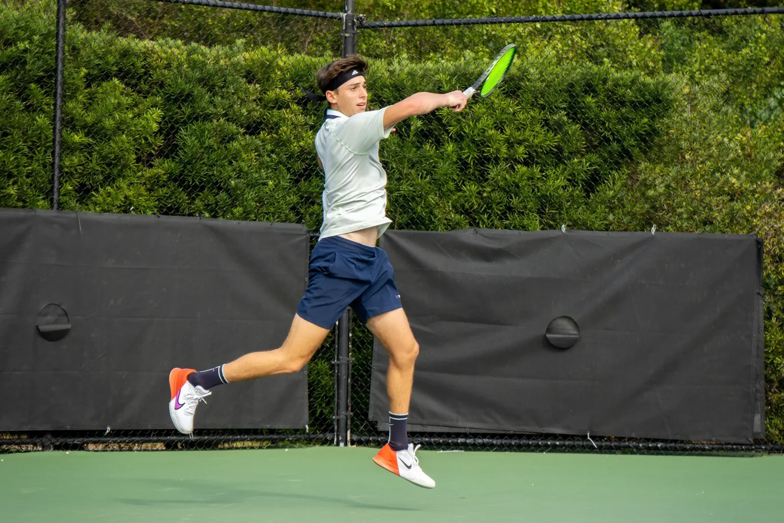 Player jumping into a forehand during a session