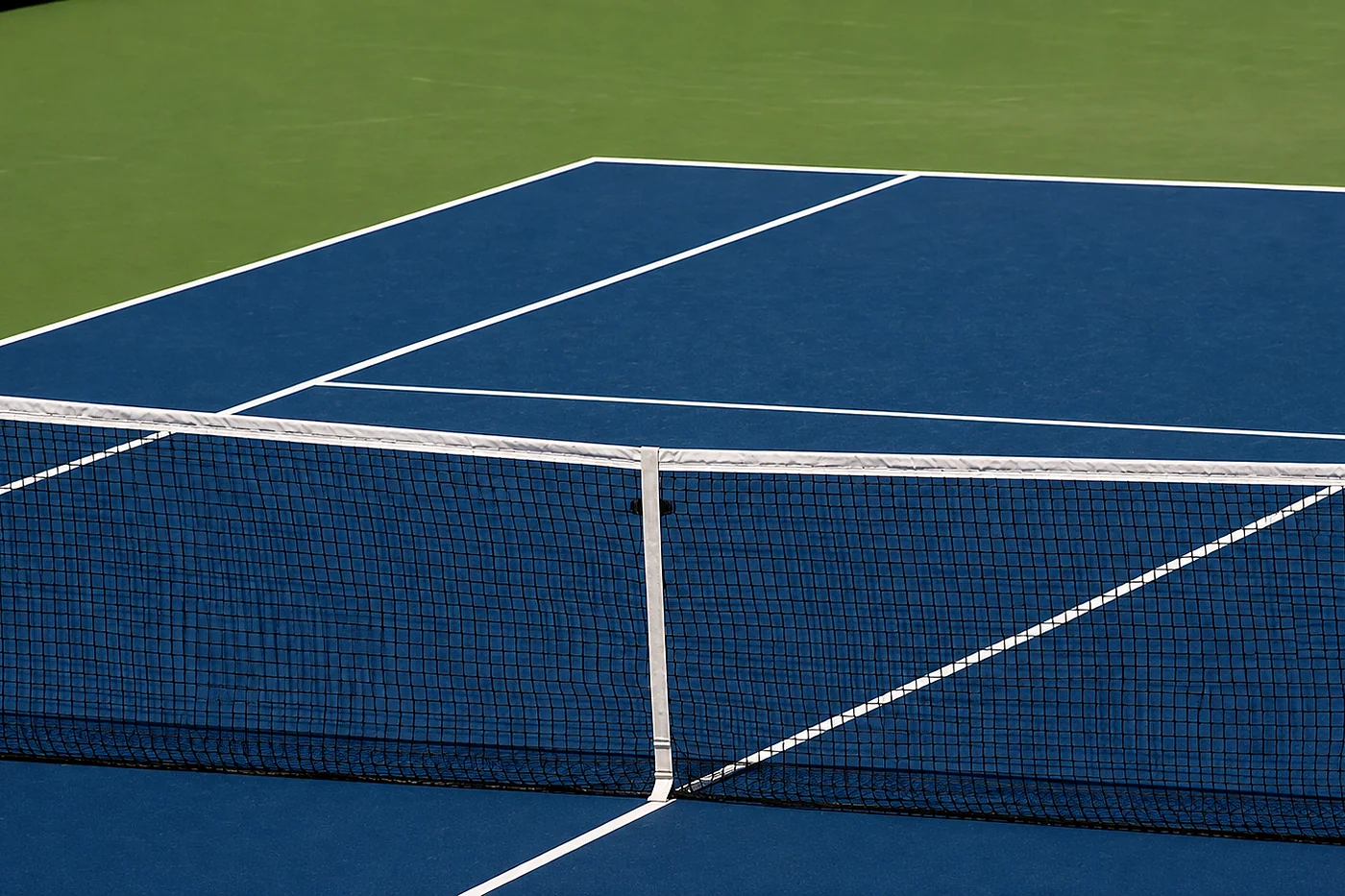 Net and service lines on a blue and green hard court